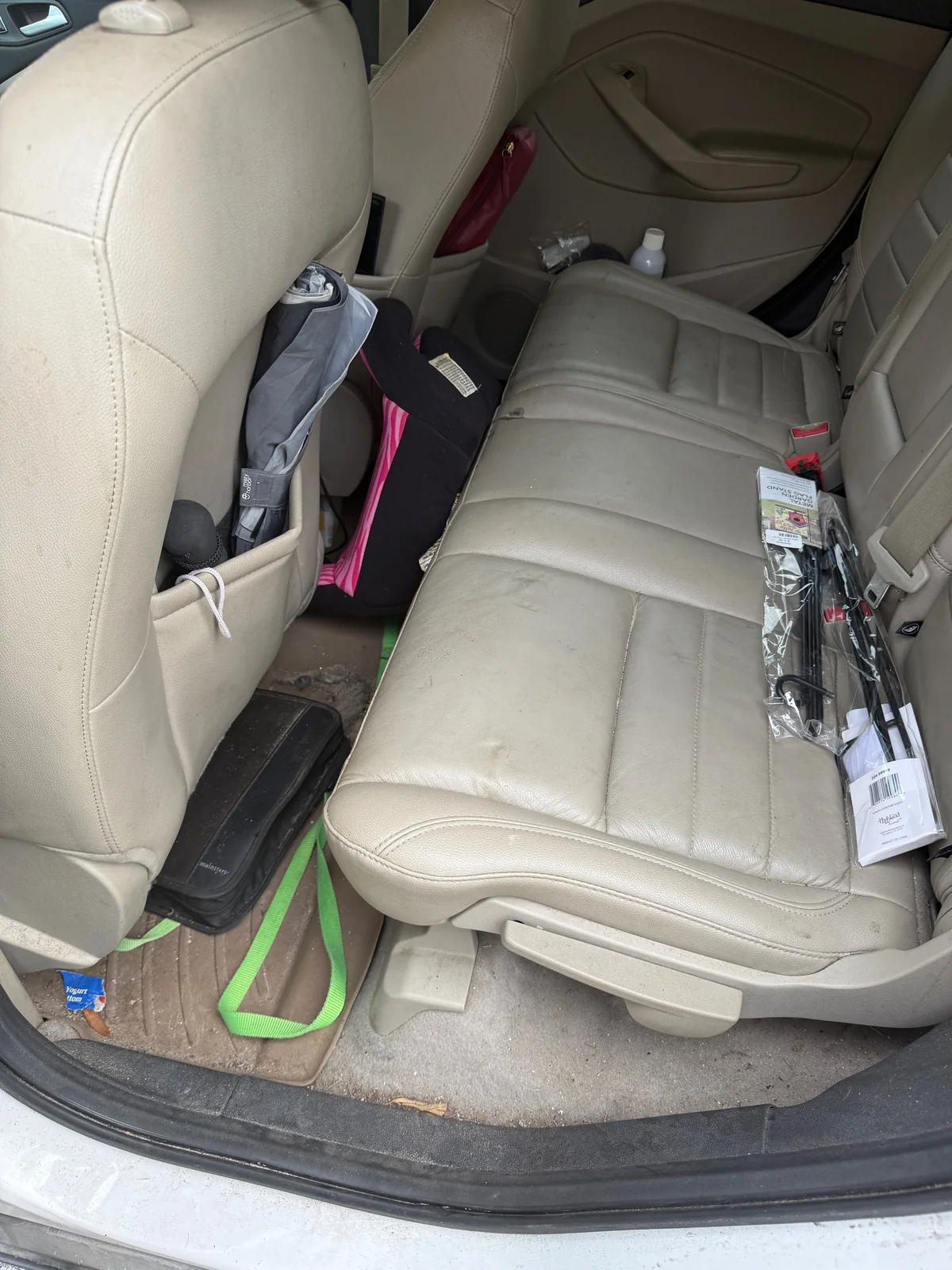 Ford Escape rear seating before detailing, with clutter and a dirty floor